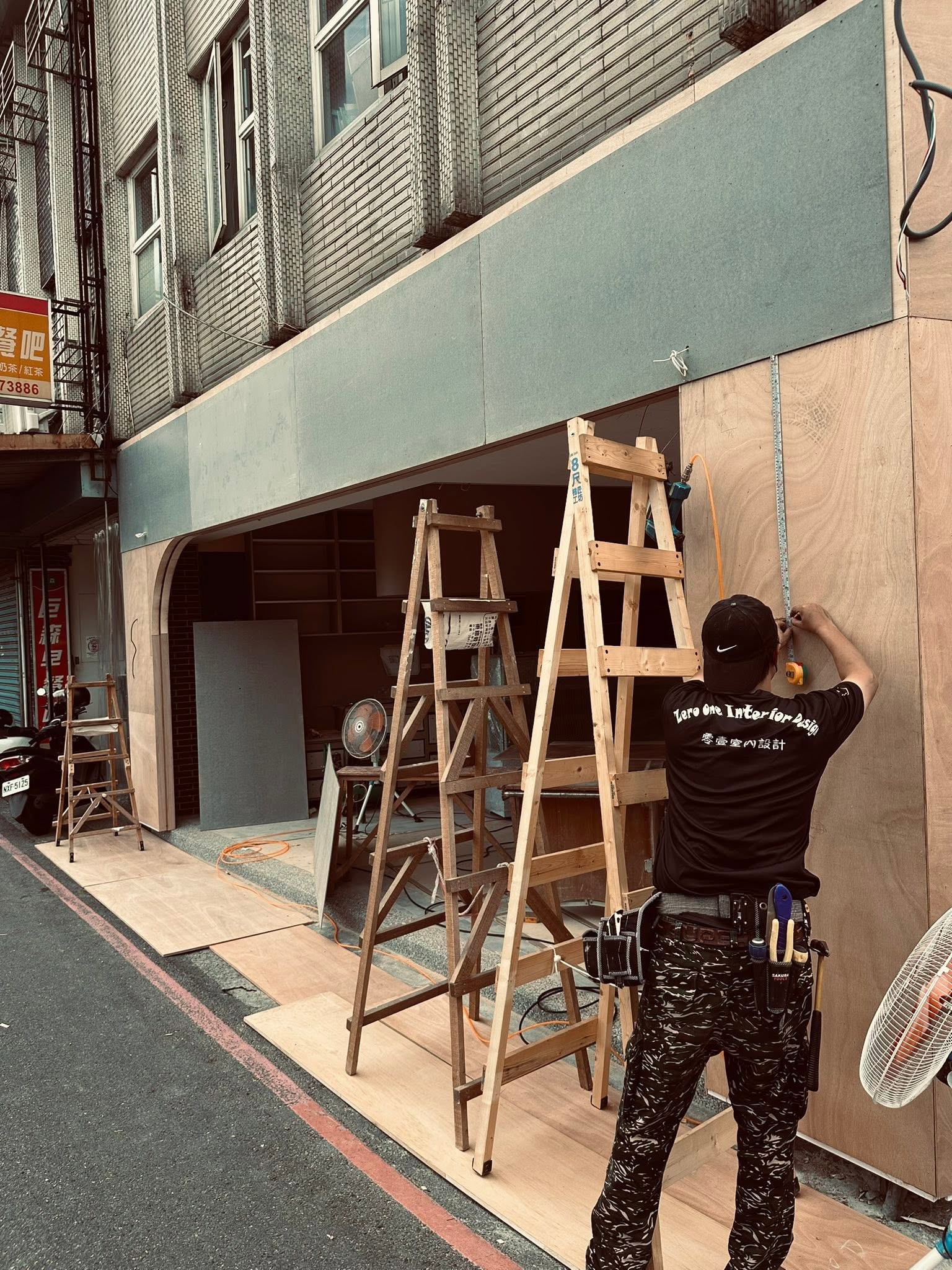 師傅在騎樓架梯子施工
